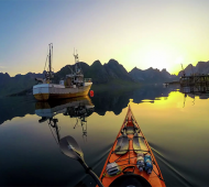 Kayaking at midnight in the fjords of Lofoten Norway